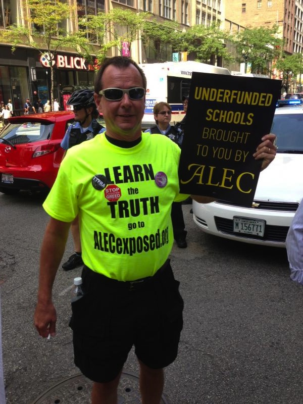Man wearing t-shirt with "Learn the Truth, go to ALECexposed.org" (Source: Nick Surgey)