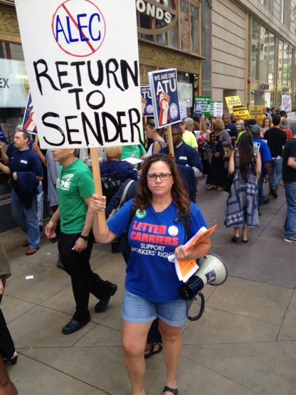 Woman holding sign with "No ALEC: Return to Sender" (Source: Brendan Fischer)