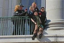 Ray drags a distraught protester off a Capitol balcony.