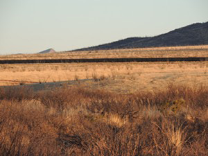 Grasslands and border wall in the area of Howard Buffett's Christiansen Ranch, spring 2016. (Beau Hodai)