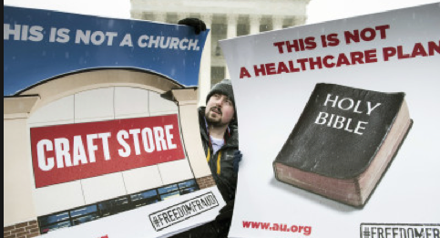 Protestors at the Supreme Court hold signs against Hobby Lobby.
