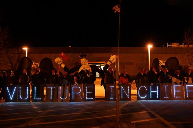 Sensata workers with Vulture In Chief sign in front of Sensata plant