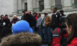 Michael Moore and Mahlon Mitchell, president of the Professional Fire Fighters of Wisconsin (photo by Jonathan Rosenblum)