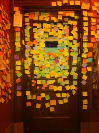 Representative Brett Husley's office door papered with post-its from unions, students and regular citizens thanking him for staying around the Capitol to oppose SB 11.