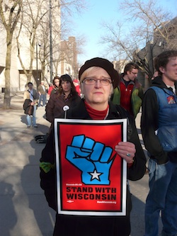 Woman holding Wisconsin "blue fist" sign