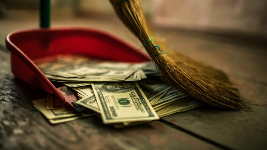 Broom sweeping money